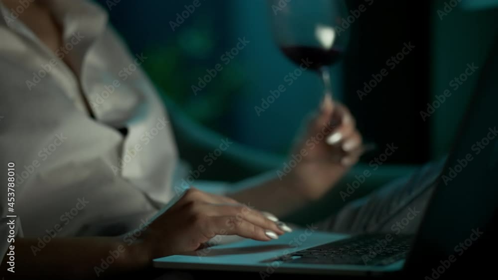 Businesswoman Works At Home, Drinks Wine And Viewing Information On Laptop. Woman Working On Computer With Glass Of Wine In Evening. Work At Home Concept. High Quality 4k Video. Businesswoman Works At Home, Drinks Wine And Viewing Information On Laptop. Woman Working On Computer With Glass Of Wine In Evening. Work At Home Concept. High Quality 4k Video.