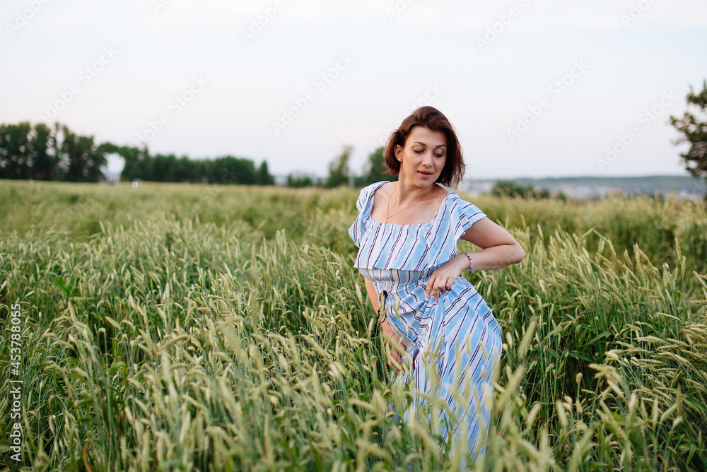 Beautiful young woman in summer in a wheat field Beautiful young woman in summer in a wheat field
