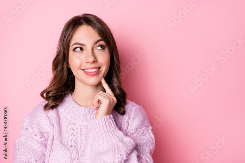 Portrait of attractive cheerful wavy-haired girl creating solution copy space ad isolated over pink pastel color background