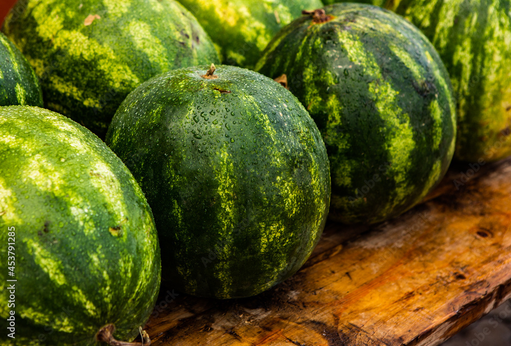 fresh watermelon with dew on wooden table fresh watermelon with dew on wooden table