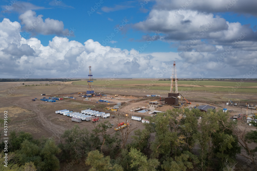 Drilling rig in oil field for drilled into subsurface in order to produced crude. Petroleum Industry. Drone view. Drilling rig in oil field for drilled into subsurface in order to produced crude. Petroleum Industry. Drone view.