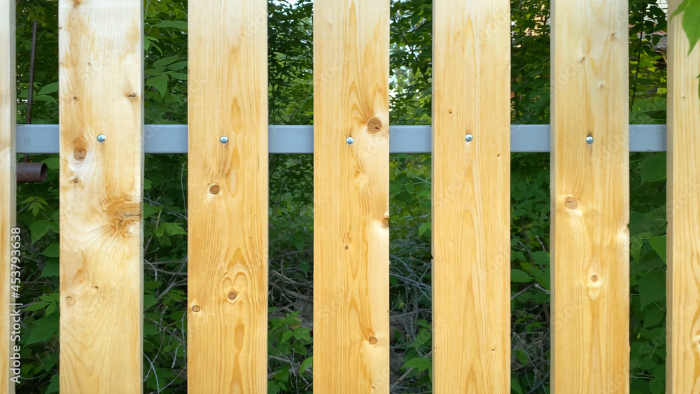 Plank brown wooden fence at summer