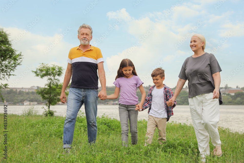 Cute children with grandparents walking in park Cute children with grandparents walking in park