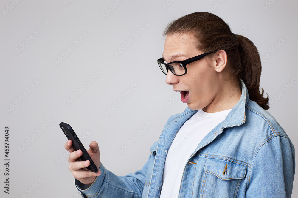 young man in glasses using smart phone young man in glasses using smart phone