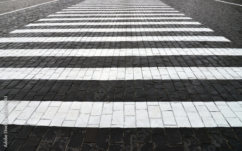 Old cobblestone pavement closeup and white line. © Vlad Ivantcov