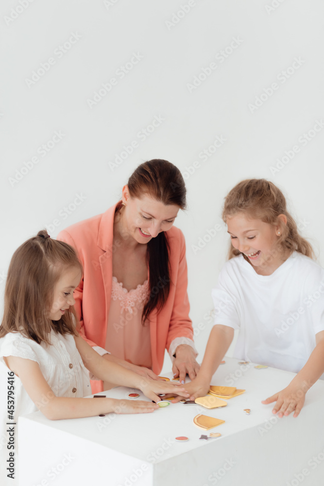 Young teacher and preschool children learn the English alphabet using cards, blocks and toys Young teacher and preschool children learn the English alphabet using cards, blocks and toys