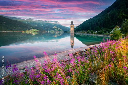 Beautiful view of the lake Resia. Famous tower in the water. Alps, Italy, Europe. Landscape photography photo