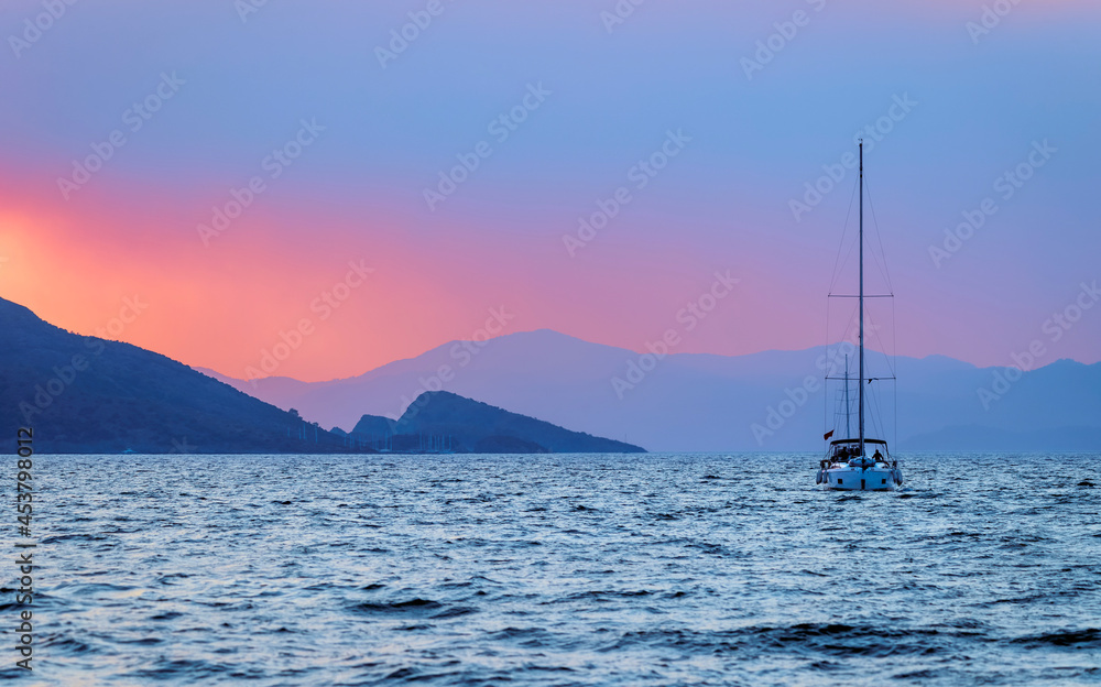 Sailboat over Sunset Sky