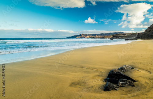 Sand and waves at La Pared beach in Furteventura, a popular surf spot