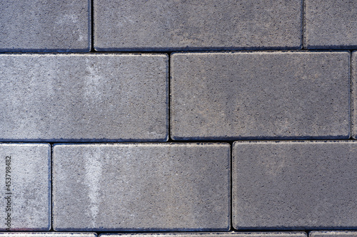 Vibro-pressed concrete paving slabs. Pattern of rectangles  bricks. Texture of road tiles