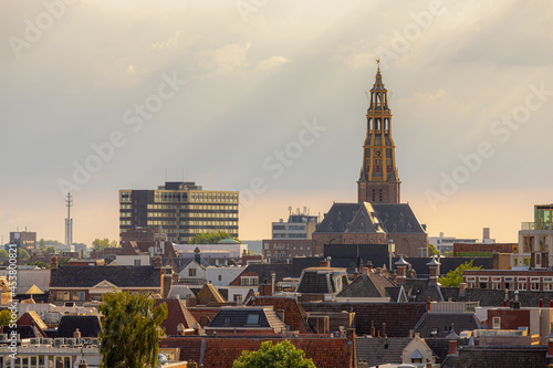Photography Overview of cityscape with architecture features traditional houses and church in evening, A city in the northern Netherlands, The capital city and main municipality of Groningen province in Holland