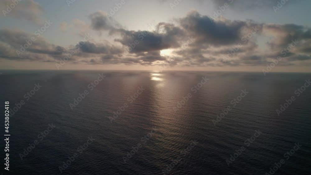 Sunrise over the sea. Epic view of the ocean and reflection of clouds and sun. Sunrise over the sea. Epic view of the ocean and reflection of clouds and sun.