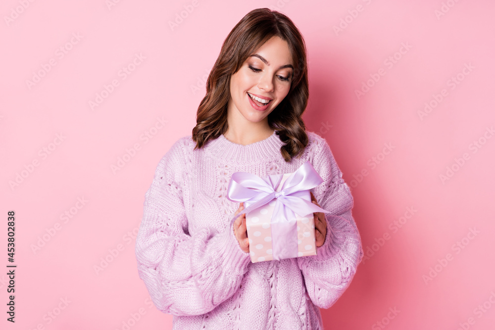 Portrait of lovely curious cheerful girl holding in hands giftbox romance isolated over pink pastel blue color background Portrait of lovely curious cheerful girl holding in hands giftbox romance isolated over pink pastel blue color background