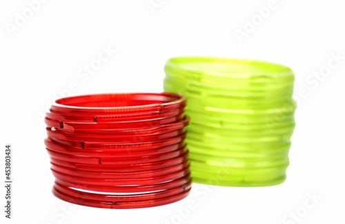 Lime green and red glass bangles isolated on white background photo