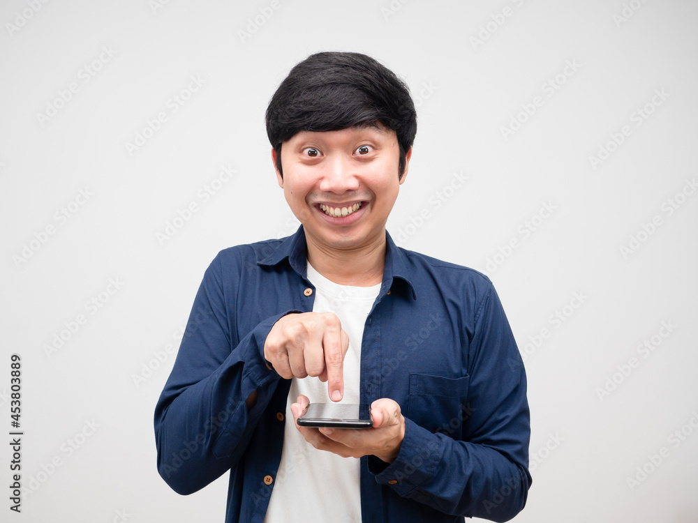 Asian man feeling excited press on smart phone in his hand Asian man feeling excited press on smart phone in his hand
