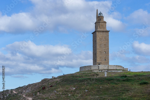 La Coruna, Spain 11-08-2018. Hercules Tower surrounded by big clouds on a beautiful day. A roman lighthouse still in use today. Unesco World Heritage © amfer75