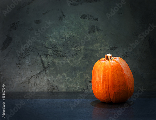 Orange pumpkin on a grey background