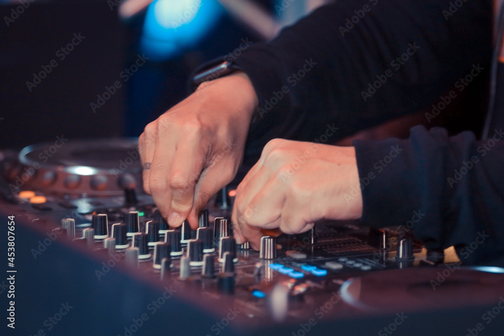 hand playing knobs on turntable hand playing knobs on turntable