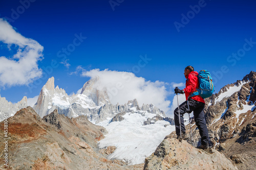 Active hiker hiking, enjoying the view, looking at Patagonia mountain landscape. mountaineering sport lifestyle concept © olyphotostories