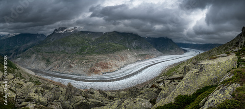 view over the strinking ice of the mighty Aletsch Glacier in the swiss alps photo