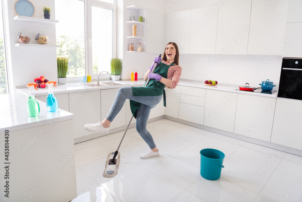 Photo of charming funky house wife wear green apron gloves cleaning kitchen singing dancing indoors room home house Photo of charming funky house wife wear green apron gloves cleaning kitchen singing dancing indoors room home house