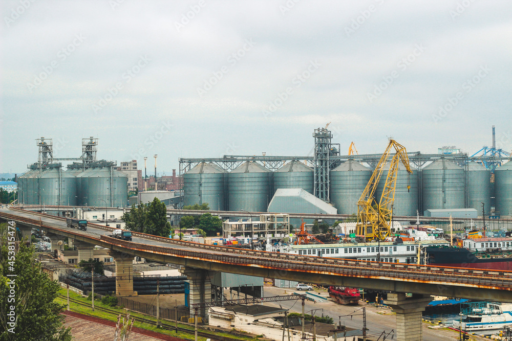 seaport with tanks and cranes and other equipment.
