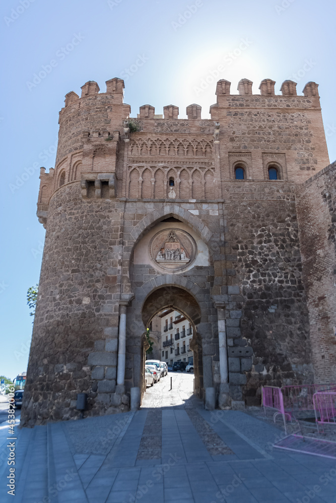 View at the Medieval Sun gate, 14th century fortress gate monument, with an arched entryway & picturesque city views, in Toledo downtown