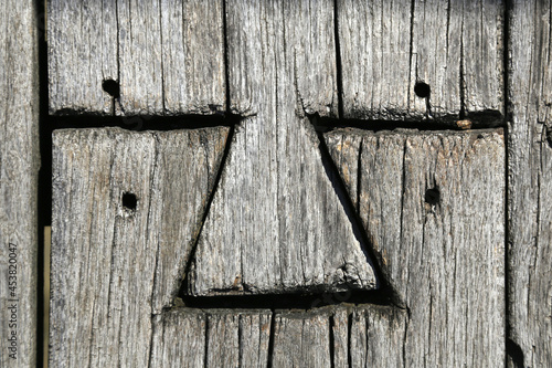 Dovetail joint of two old wooden boards photo