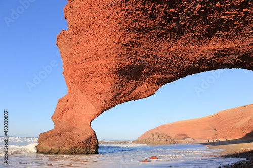 exotic orange giant rock with a hole, legzira, morocco
