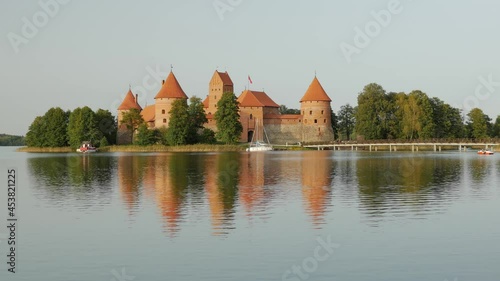 Lithuania, landscape with Trakai castle on the lakeshore. Trakai Castle is one of the major tourist attractions of Lituania. photo