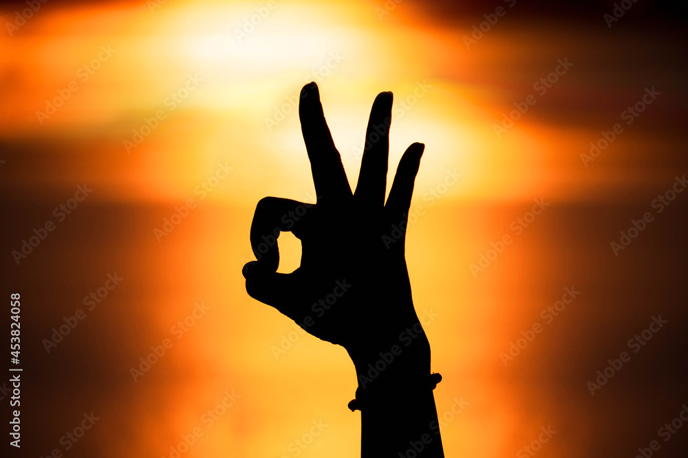 Silhouette hand in ok shape with sunset,Love concept. Happy Valentine's Day
