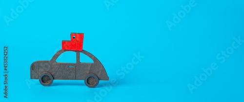 New year, christmas concept. Car with New Year's gifts on the roof on a blue background. Banner, Christmas background.