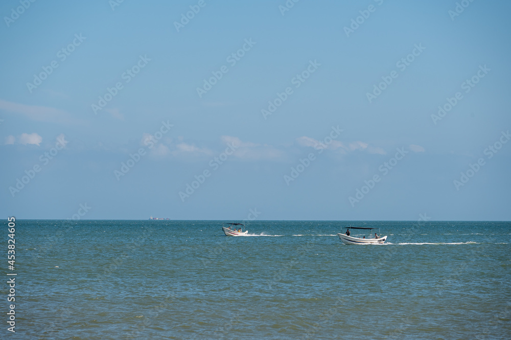 On a sunny day in summer, the speedboat drove fast in the blue sea