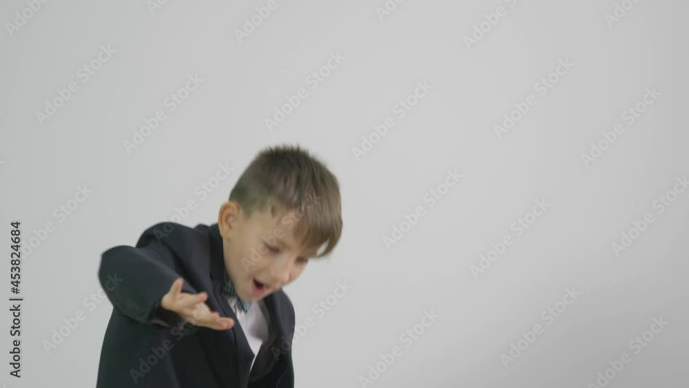 Funny child with suit countering and throw off with money, dance of joy, rich attitude Funny child with suit countering and throw off with money, dance of joy, rich attitude