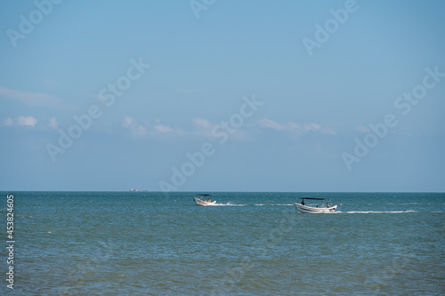 On a sunny day in summer, the speedboat drove fast in the blue sea