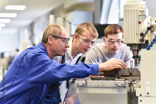 Group of young people in technical vocational training with teacher photo