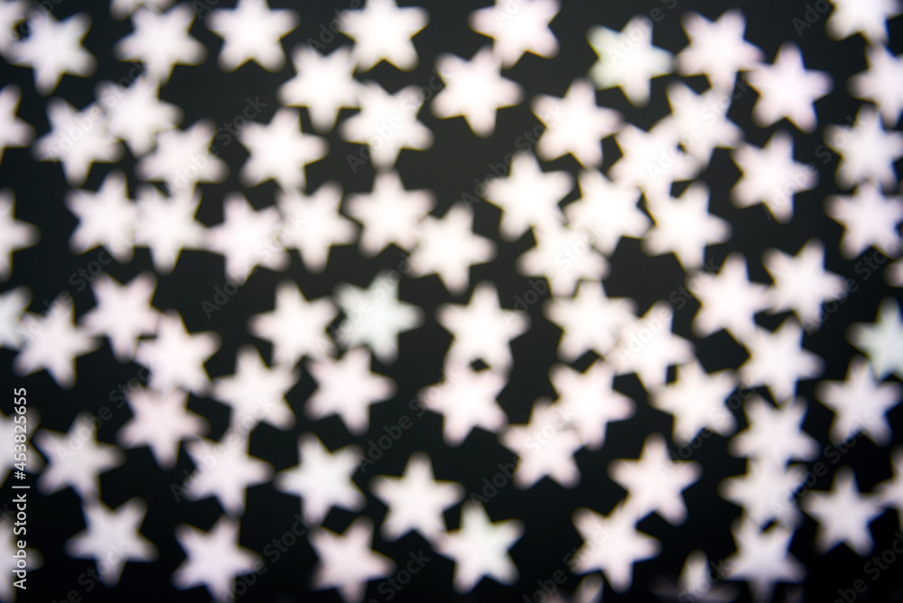Confetti stars on black background, out of focus. Confetti stars on black background, out of focus.