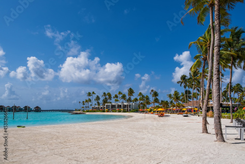 Fototapeta Naklejka Na Ścianę i Meble -  Hotel maldives buildings with palms against the background of emerald water. Group of islands Crossroads Maldives, july 2021. South Male atoll