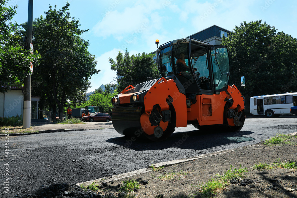Roller working on city street. Road repairing Roller working on city street. Road repairing