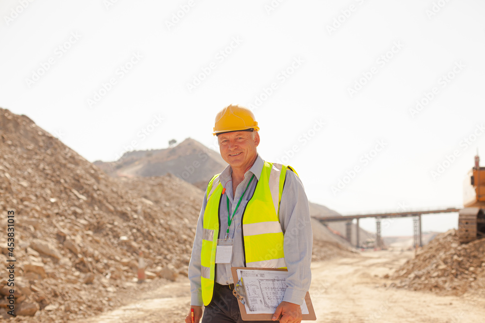 Businessman and worker reading blueprints on site Businessman and worker reading blueprints on site