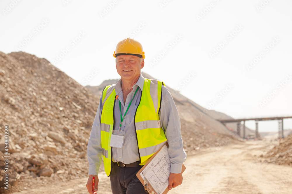 Businessman and worker reading blueprints on site Businessman and worker reading blueprints on site