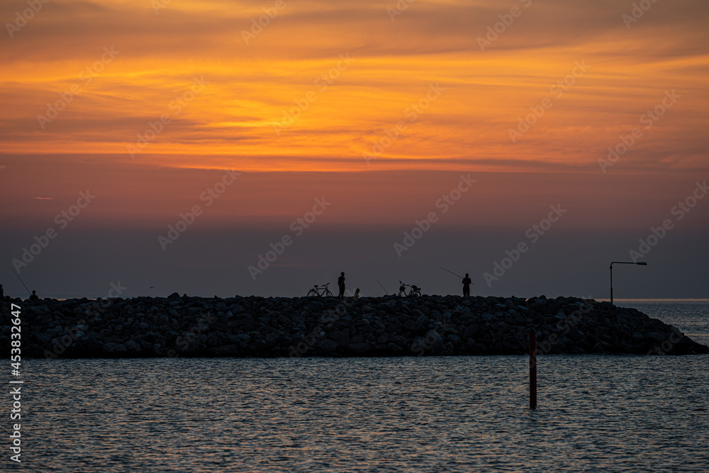 An amazing sunset over the ocean. Sky and ocean glowing in orange An amazing sunset over the ocean. Sky and ocean glowing in orange