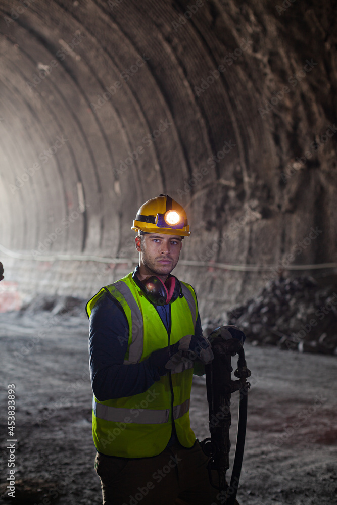 Businessman and worker standing in tunnel Businessman and worker standing in tunnel