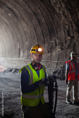 Businessman and worker standing in tunnel