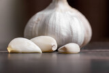 Garlic cloves and head close-up on a wooden background