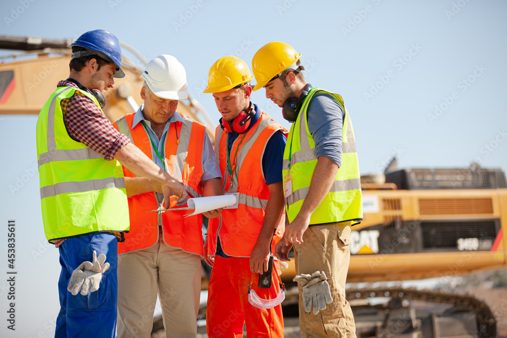 Worker standing on machinery on site Worker standing on machinery on site