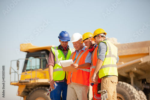 Worker standing by machinery on site