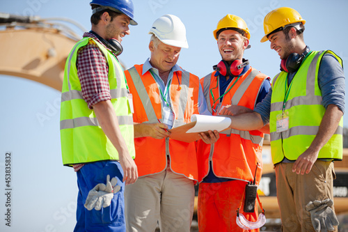 Worker standing on machinery on site