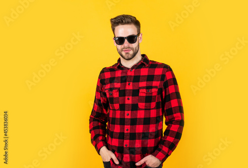 cool and sexy. well groomed hairstyle. male beauty and fashion look. checkered shirt for bearded guy. unshaven handsome man with bristle in sunglasses. hairdresser concept. young and confident