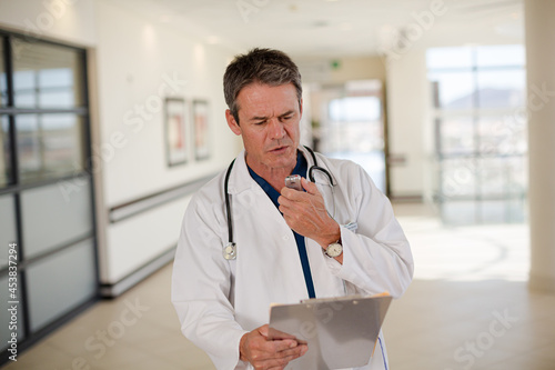 Doctor talking into dictaphone photo